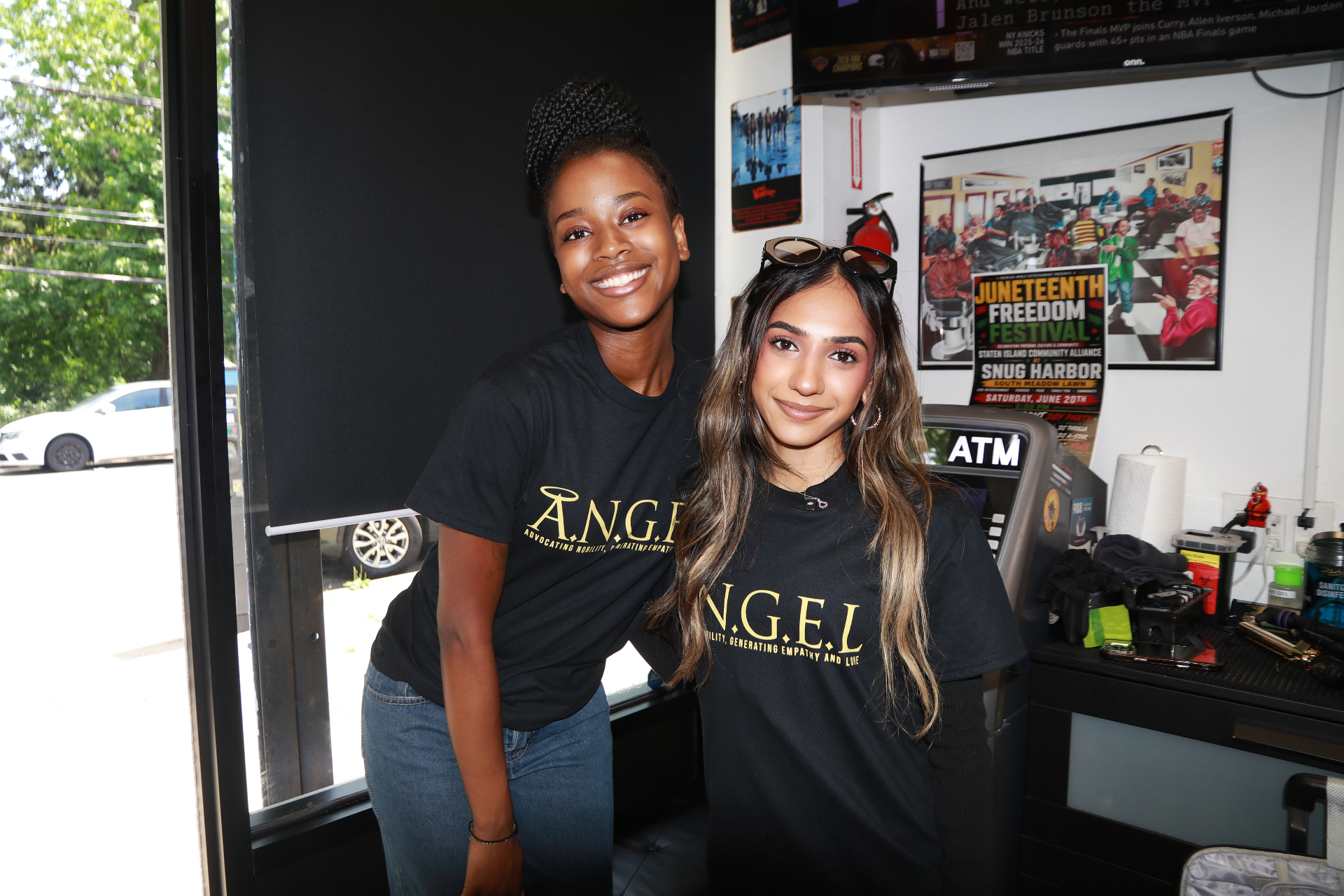Two ANGEL team members in branded shirts